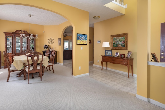 3265 Scottish Trce, Lexington, KY 40509 - dining room featuring arched walkways, a chandelier, and carpet flooring