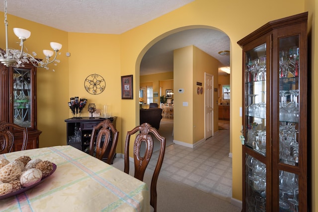 3265 Scottish Trce, Lexington, KY 40509 - dining room with arched walkways, tile patterned floors, a chandelier, and a textured ceiling