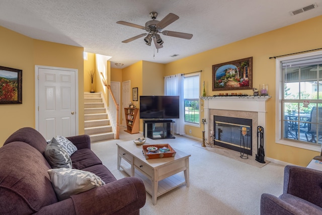 3265 Scottish Trce, Lexington, KY 40509 - carpeted living room with stairs, plenty of natural light, a fireplace, and ceiling fan