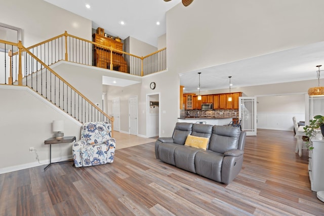 115 Westwoods Dr, Georgetown, KY 40324 - living room featuring wood finished floors, stairway, recessed lighting, and a towering ceiling