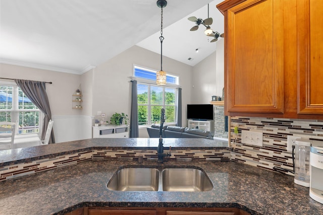 115 Westwoods Dr, Georgetown, KY 40324 - kitchen featuring brown cabinets, backsplash, dark stone counters, pendant lighting, and open floor plan