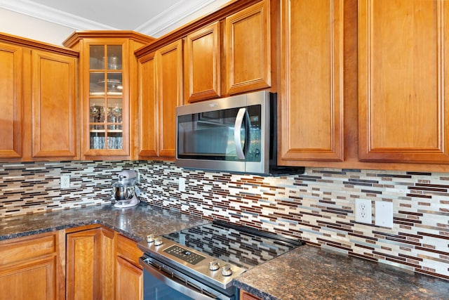 115 Westwoods Dr, Georgetown, KY 40324 - kitchen with stainless steel appliances, brown cabinets, backsplash, ornamental molding, and glass insert cabinets