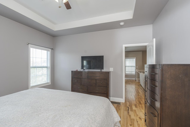 3224 Orchard Grass Rd, Lexington, KY 40509 - bedroom featuring light wood-style flooring, a raised ceiling, and a ceiling fan