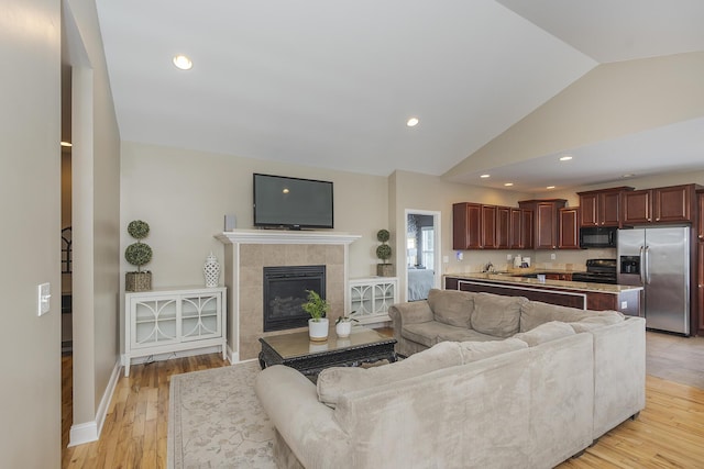 3224 Orchard Grass Rd, Lexington, KY 40509 - living area with lofted ceiling, light wood-style floors, a tiled fireplace, and recessed lighting