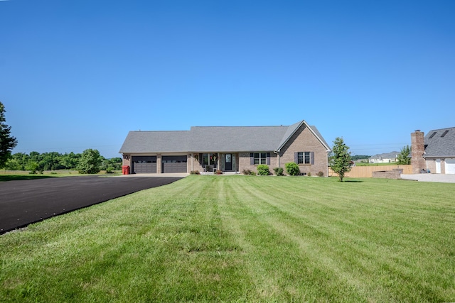 196 Herndon Ln, Berea, KY 40403 - single story home with asphalt driveway, an attached garage, and brick siding