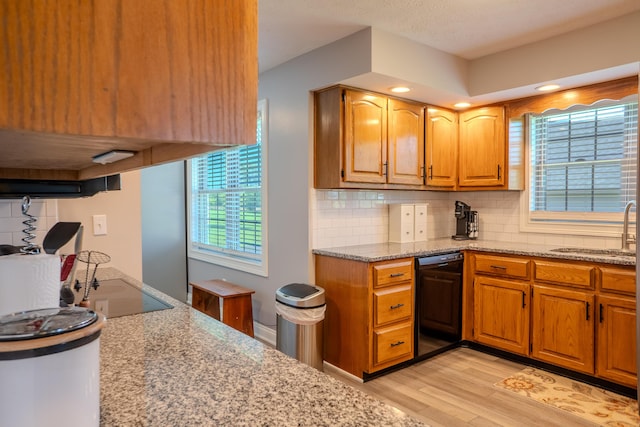 196 Herndon Ln, Berea, KY 40403 - kitchen with black appliances, light wood-type flooring, light stone counters, backsplash, and brown cabinets