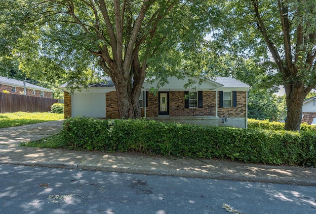 204 Kelly St, Paris, KY 40361 - view of front facade with brick siding, concrete driveway, an attached garage, and a porch