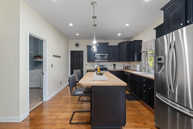 101 Rock Bridge Ct, Georgetown, KY 40324 - kitchen featuring appliances with stainless steel finishes, wood counters, a kitchen breakfast bar, a kitchen island, and light wood-style flooring