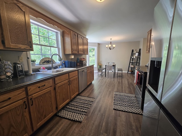 10 Thaxted Ln, Middlesboro, KY 40965 - kitchen with stainless steel appliances, dark wood-style flooring, a chandelier, dark countertops, and brown cabinets