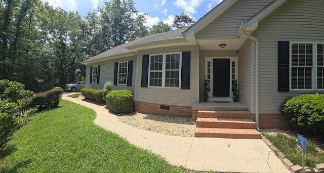 10 Thaxted Ln, Middlesboro, KY 40965 - view of exterior entry featuring a yard, roof with shingles, and crawl space