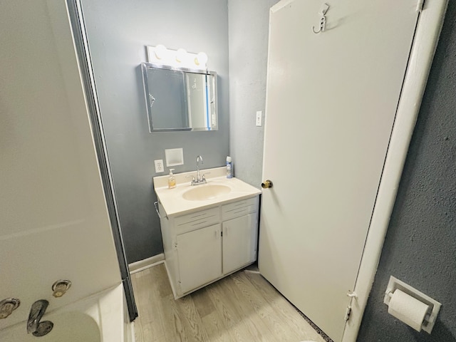 243 Walnut St, Crab Orchard, KY 40419 - full bathroom with vanity and wood finished floors