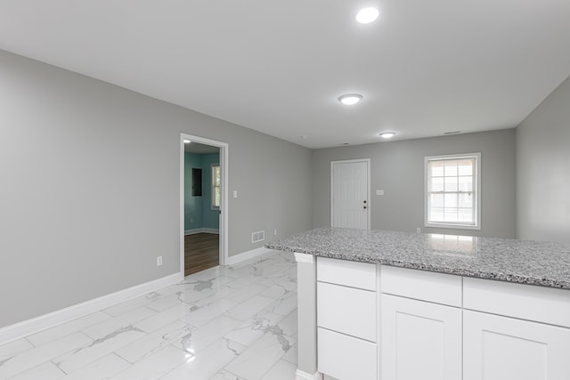 223 Race St, Lexington, KY 40508 - kitchen featuring light marble finish flooring, white cabinets, light stone countertops, and recessed lighting