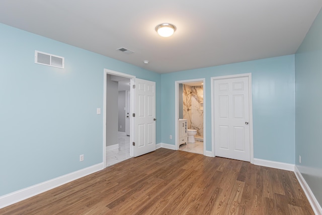 223 Race St, Lexington, KY 40508 - unfurnished bedroom featuring wood finished floors and ensuite bathroom