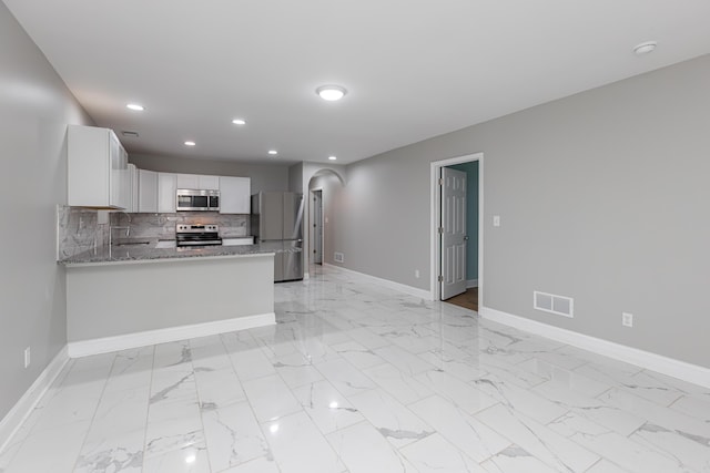 223 Race St, Lexington, KY 40508 - kitchen with stainless steel appliances, light marble finish floors, recessed lighting, white cabinets, and tasteful backsplash