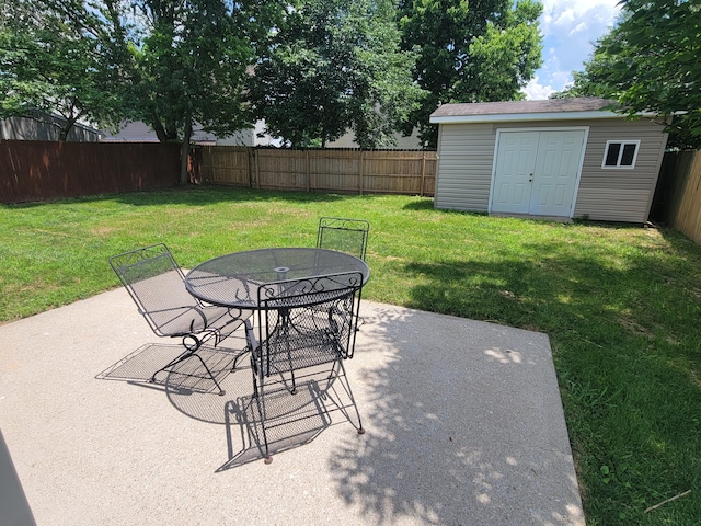 215 Wilderness Cove Ln, Georgetown, KY 40324 - fenced backyard featuring a patio, a storage unit, and outdoor dining area