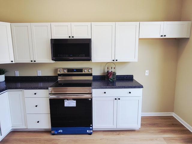 215 Wilderness Cove Ln, Georgetown, KY 40324 - kitchen with black microwave, electric range, white cabinetry, and light wood-type flooring