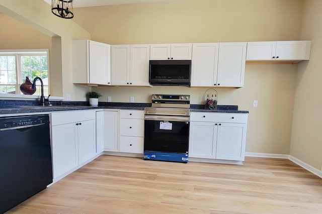 215 Wilderness Cove Ln, Georgetown, KY 40324 - kitchen featuring black appliances, white cabinetry, light wood-type flooring, lofted ceiling, and dark stone countertops