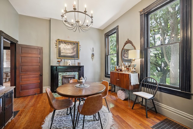 456 N Limestone St, Lexington, KY 40508 - dining room with a chandelier, wood finished floors, and a fireplace