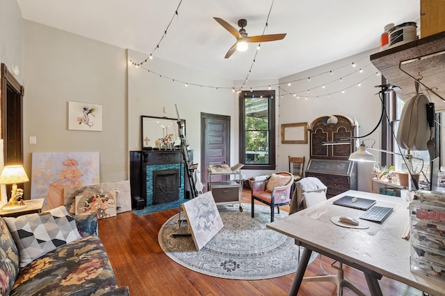 456 N Limestone St, Lexington, KY 40508 - living area with wood finished floors, a ceiling fan, and a fireplace with flush hearth