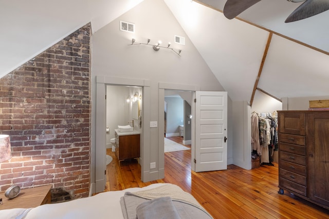 456 N Limestone St, Lexington, KY 40508 - bedroom with wood-type flooring, lofted ceiling, connected bathroom, a walk in closet, and a closet