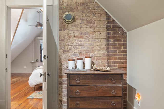 456 N Limestone St, Lexington, KY 40508 - bedroom with vaulted ceiling, wood finished floors, and brick wall