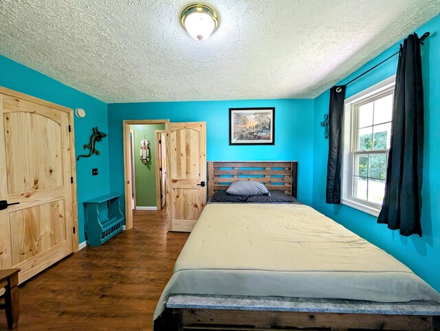 1260 Old Way Rd, London, KY 40741 - bedroom with dark wood-style flooring and a textured ceiling
