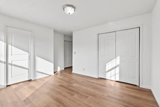 1142 Kiowa Trl, Frankfort, KY 40601 - unfurnished bedroom featuring two closets and light wood-style floors