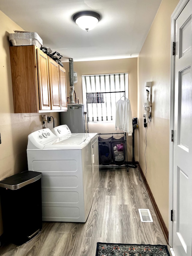 525 Scenic Dr, Harrodsburg, KY 40330 - washroom featuring cabinet space, washing machine and dryer, gas water heater, and wood finished floors
