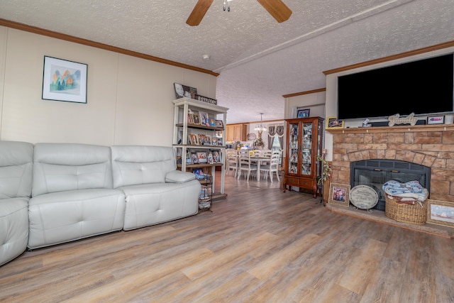494 Janice Ln, Owingsville, KY 40360 - living room featuring a ceiling fan, ornamental molding, wood finished floors, a textured ceiling, and a fireplace