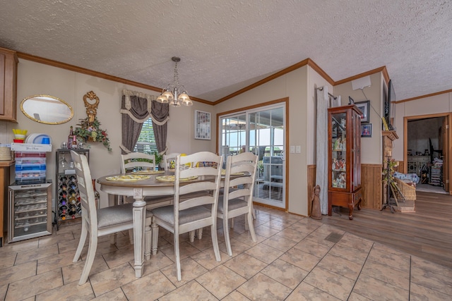 494 Janice Ln, Owingsville, KY 40360 - dining space with crown molding, beverage cooler, a chandelier, wainscoting, and a textured ceiling