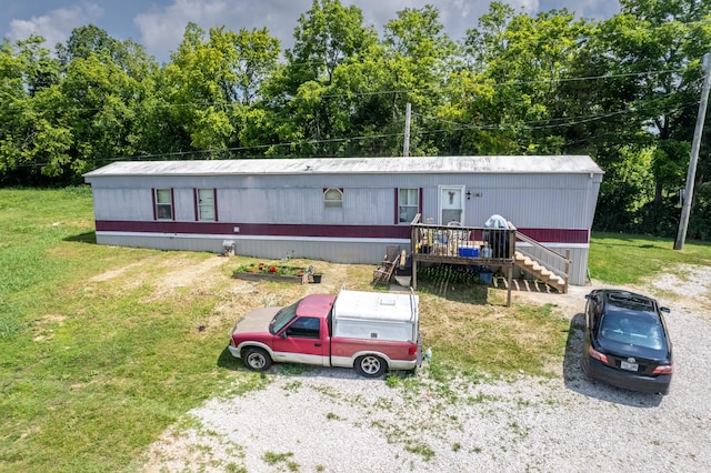 494 Janice Ln, Owingsville, KY 40360 - manufactured / mobile home featuring a front lawn and view of scattered trees
