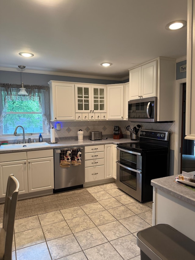 1310 Lago Dr, Frankfort, KY 40601 - kitchen with stainless steel appliances, tasteful backsplash, white cabinetry, ornamental molding, and recessed lighting