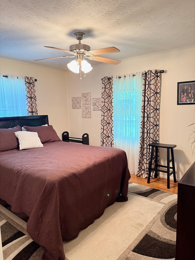 1310 Lago Dr, Frankfort, KY 40601 - bedroom featuring a textured ceiling, multiple windows, ceiling fan, and wood finished floors
