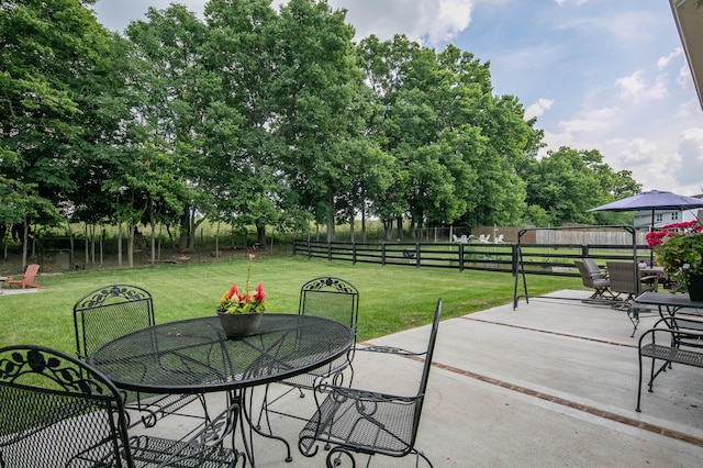 136 Rocky Creek Rd, Georgetown, KY 40324 - fenced backyard featuring outdoor dining space, a patio area, and view of wooded area
