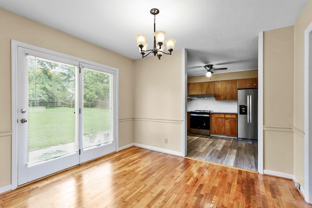 227 Gailane St, Lawrenceburg, KY 40342 - kitchen with stainless steel appliances, brown cabinets, under cabinet range hood, a chandelier, and a ceiling fan