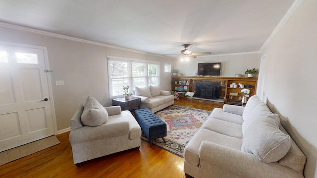 1010 Riverside Dr, Harrodsburg, KY 40330 - living area featuring ceiling fan, wood finished floors, a fireplace with raised hearth, and ornamental molding