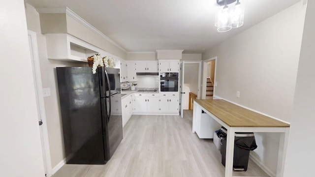 1010 Riverside Dr, Harrodsburg, KY 40330 - kitchen featuring black appliances, light wood-style floors, under cabinet range hood, light countertops, and white cabinetry