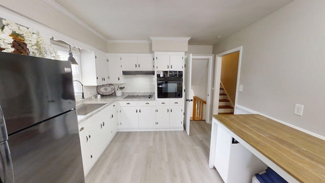 1010 Riverside Dr, Harrodsburg, KY 40330 - kitchen featuring black appliances, light wood-type flooring, white cabinets, ornamental molding, and under cabinet range hood