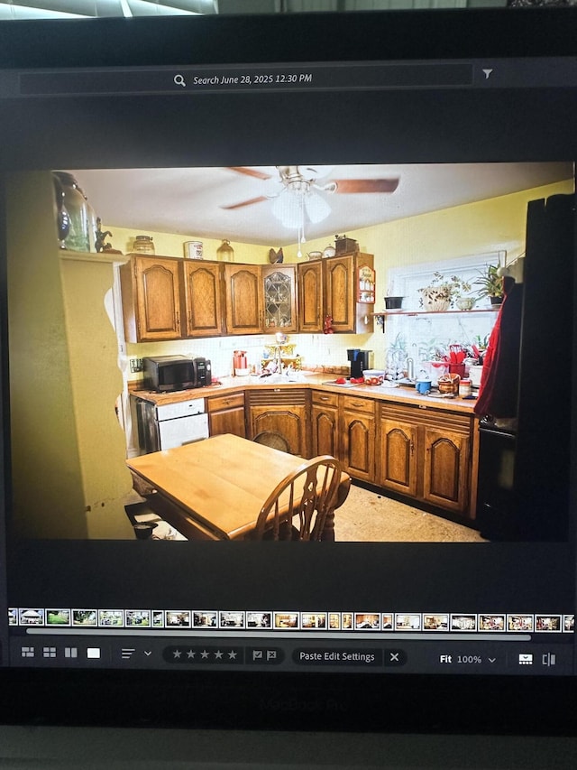 410 Oak St, Georgetown, KY 40324 - kitchen featuring brown cabinetry, light countertops, ceiling fan, and black appliances