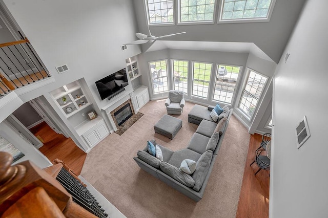 4612 Marlberry Pl, Lexington, KY 40509 - living room with a fireplace with flush hearth, plenty of natural light, a towering ceiling, built in features, and a ceiling fan