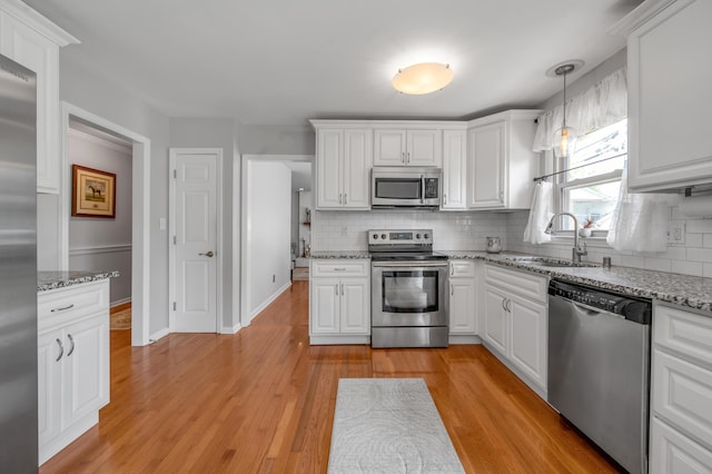 2864 Ark Royal Way, Lexington, KY 40503 - kitchen featuring stainless steel appliances, decorative backsplash, white cabinets, and light wood finished floors