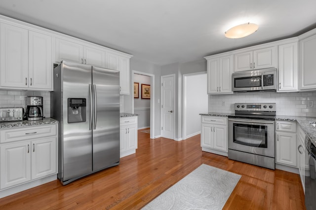 2864 Ark Royal Way, Lexington, KY 40503 - kitchen featuring appliances with stainless steel finishes, white cabinetry, decorative backsplash, and light wood-type flooring
