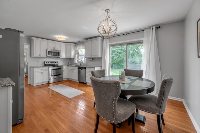 2864 Ark Royal Way, Lexington, KY 40503 - dining room featuring a chandelier and light wood-style floors