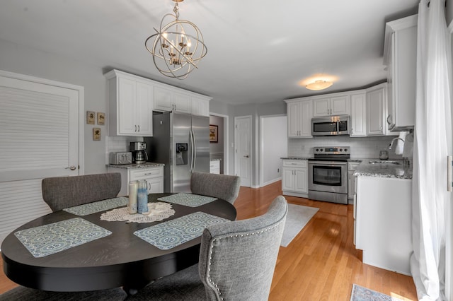 2864 Ark Royal Way, Lexington, KY 40503 - dining area with a chandelier and light wood-style floors