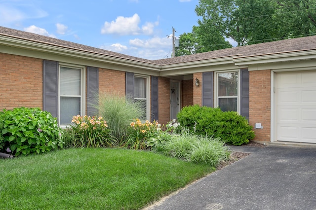 2864 Ark Royal Way, Lexington, KY 40503 - view of front facade with brick siding, a front yard, and a garage