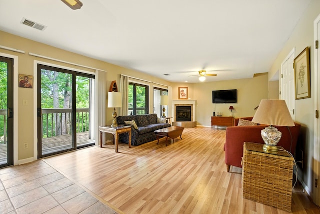 1011 Hancock Cir Unit 9-10, Harrodsburg, KY 40330 - living area featuring a ceiling fan, a glass covered fireplace, and light wood finished floors