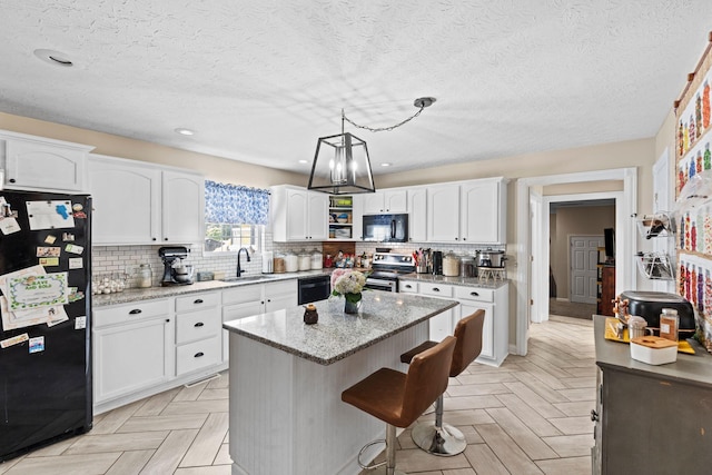 997 Copper Creek Rd, Berea, KY 40403 - kitchen featuring black appliances, white cabinets, light stone countertops, decorative backsplash, and a textured ceiling