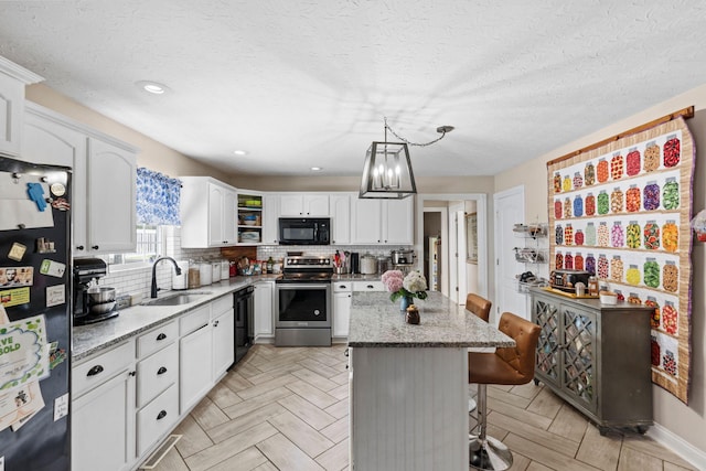 997 Copper Creek Rd, Berea, KY 40403 - kitchen featuring black appliances, a breakfast bar, white cabinetry, tasteful backsplash, and light stone countertops
