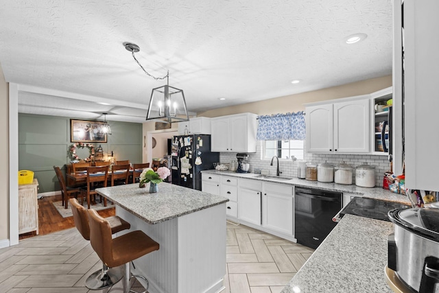 997 Copper Creek Rd, Berea, KY 40403 - kitchen featuring black appliances, a kitchen island, white cabinetry, a kitchen bar, and a textured ceiling