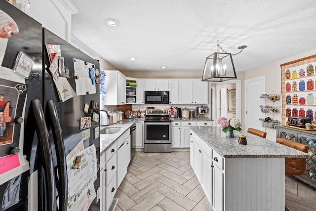 997 Copper Creek Rd, Berea, KY 40403 - kitchen featuring black appliances, white cabinets, a kitchen island, a chandelier, and light stone countertops